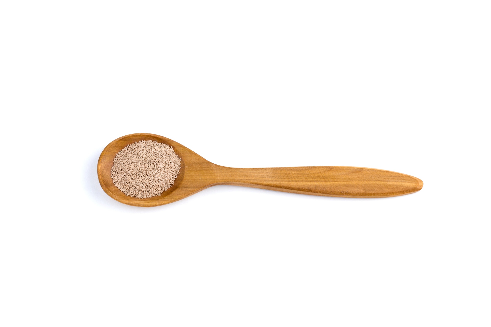yeast top view of a spoon of sandal wood isolated on white background